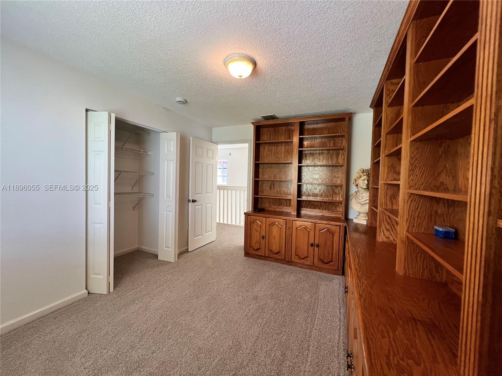 12247 Southwest 140th Street Miami, FL 33186 - Photo 53 of 86 a view of an empty room with cabinet and a window