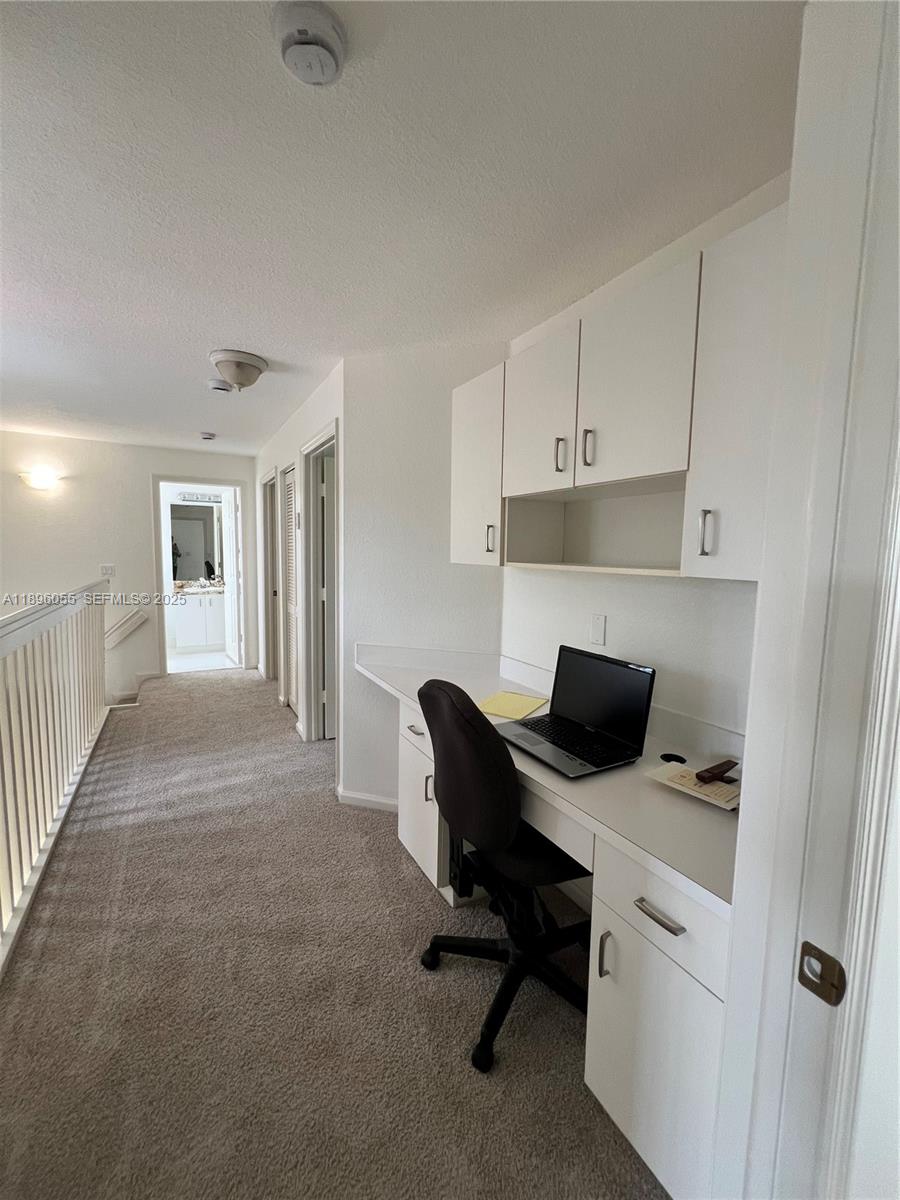 12247 Southwest 140th Street Miami, FL 33186 - Photo 58 of 86 a view of a workspace with furniture and a window