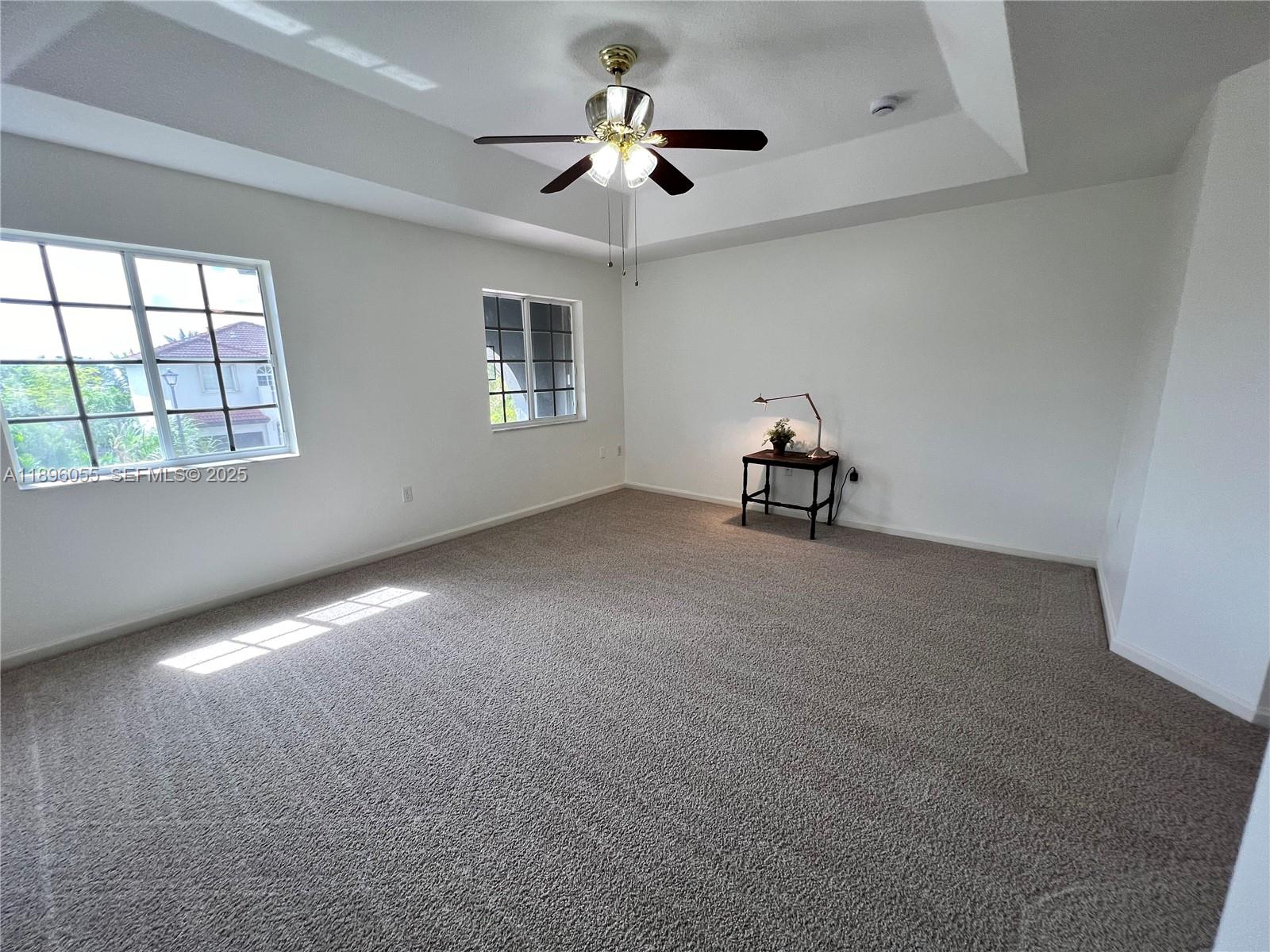 12247 Southwest 140th Street Miami, FL 33186 - Photo 61 of 86 an empty room with windows and ceiling fan view
