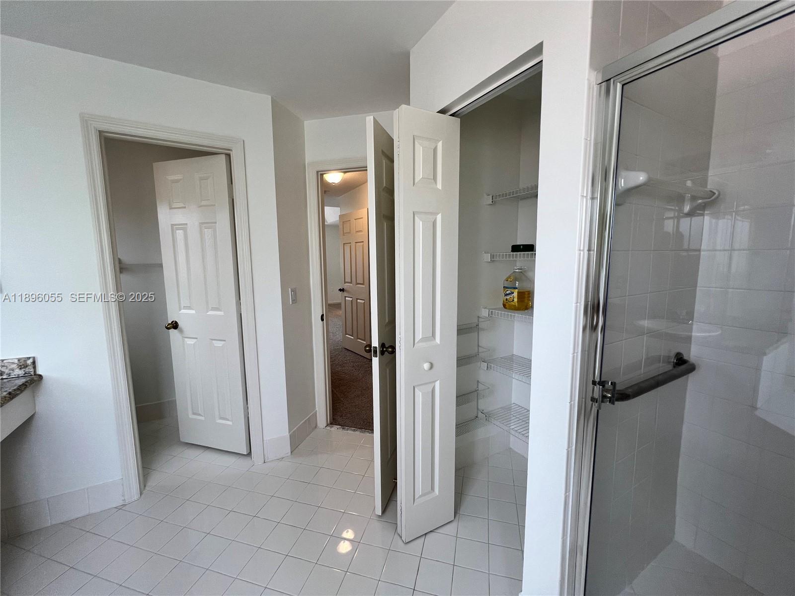 12247 Southwest 140th Street Miami, FL 33186 - Photo 68 of 86 a bathroom with a shower and a mirror