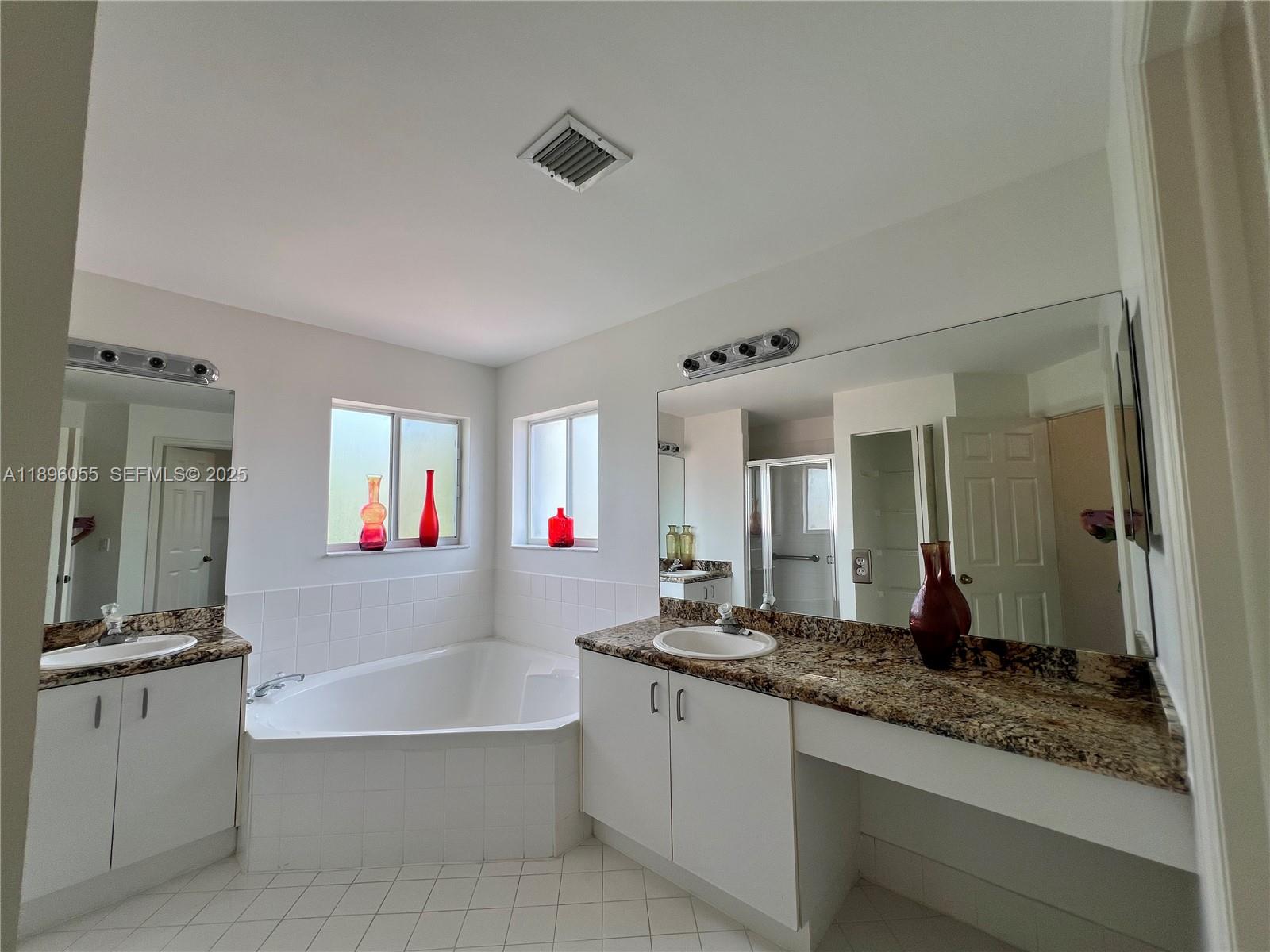 12247 Southwest 140th Street Miami, FL 33186 - Photo 70 of 86 a bathroom with sink bathtub and mirror