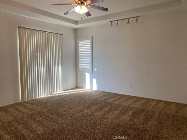 a view of a livingroom with a ceiling fan and window