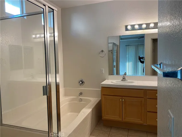 a bathroom with a tub sink and mirror