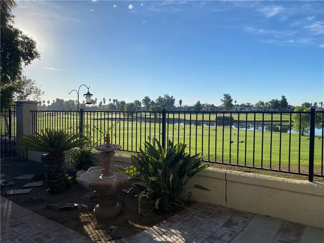 a view of a terrace with couches and wooden fence