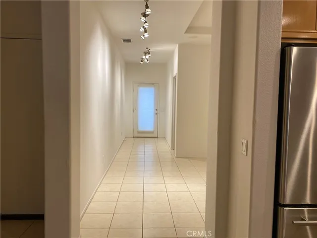 a view of hallway with a shower and a fireplace