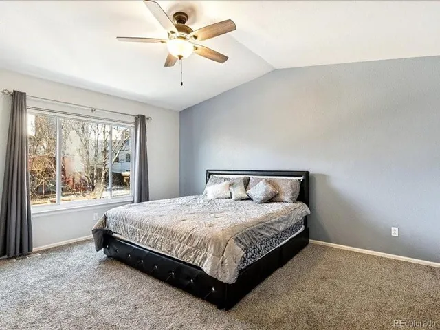 a bedroom with a large bed and a large window