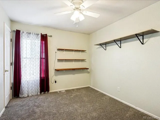 a room with closet and ceiling fan