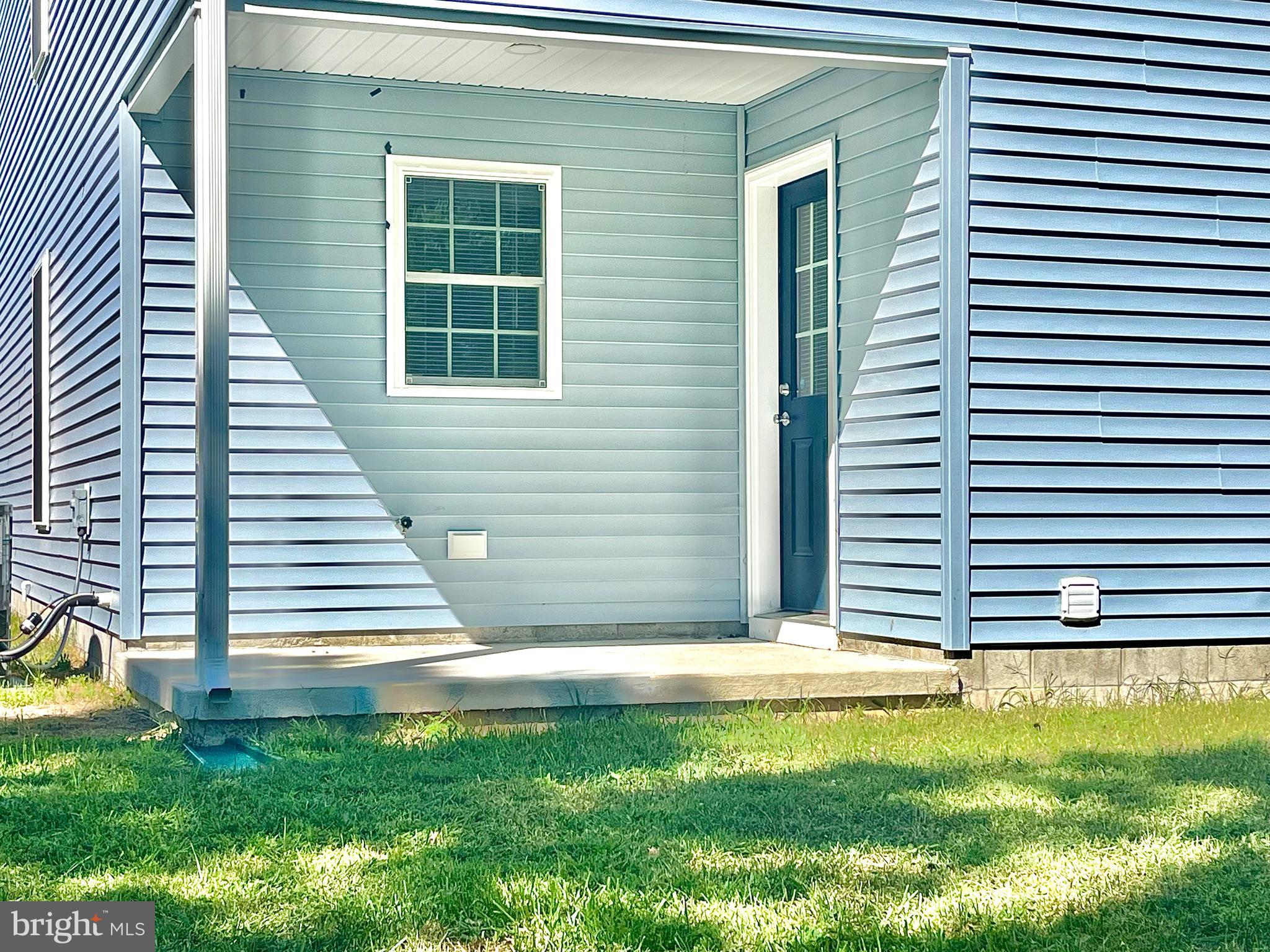 46 Meadowood Lane Harrington, DE 19952 - Photo 2 of 15 a view of a backyard with plants and a barbeque grill