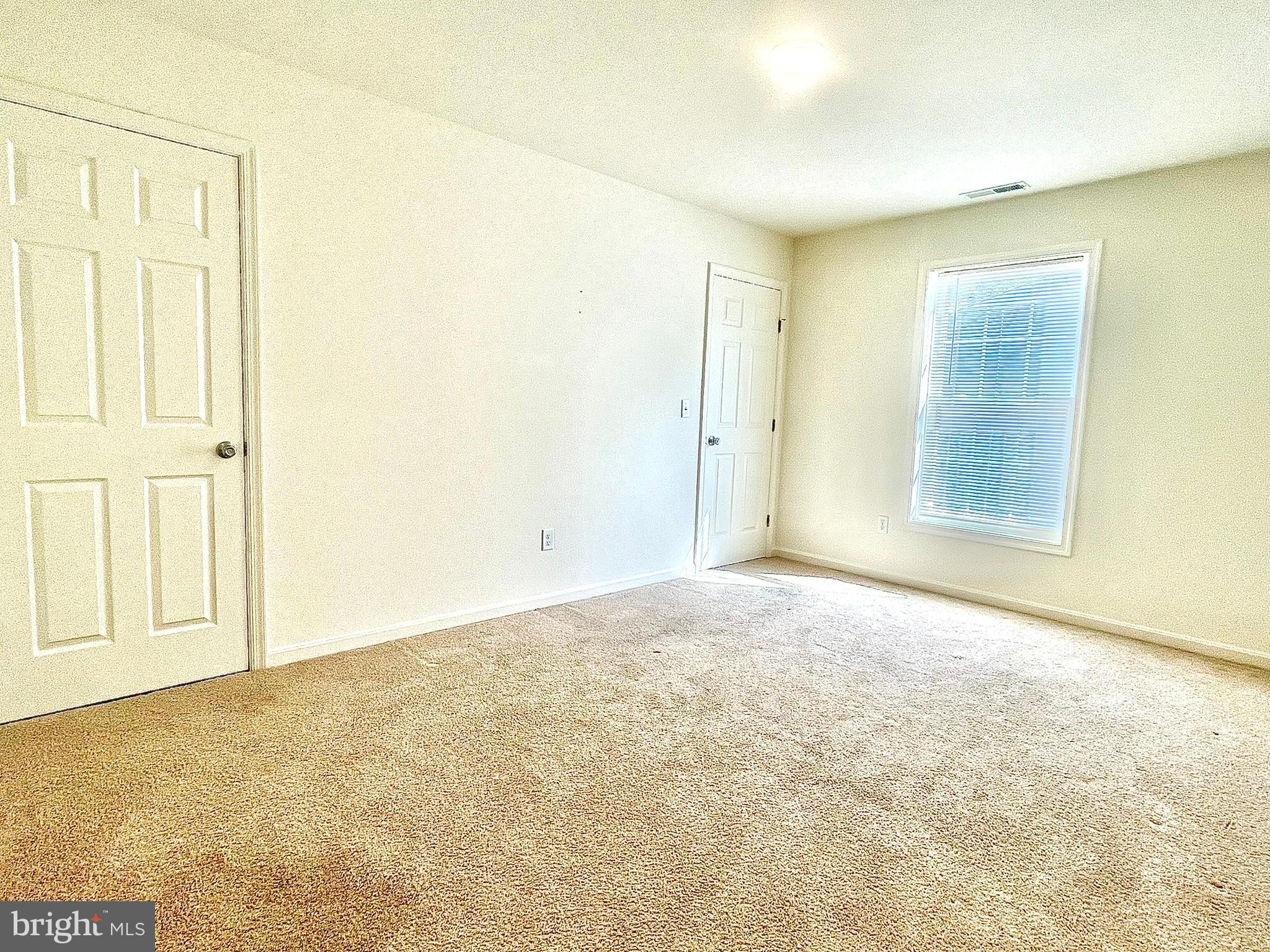 46 Meadowood Lane Harrington, DE 19952 - Photo 10 of 15 an empty room with a empty space and a window