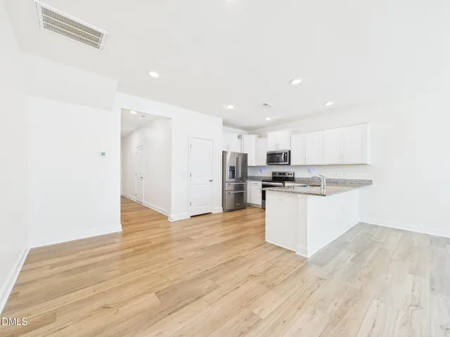 a kitchen with stainless steel appliances a refrigerator sink and cabinets
