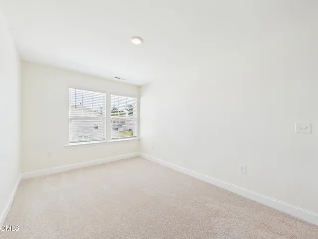 a view of a room with wooden floor outdoor space and windows
