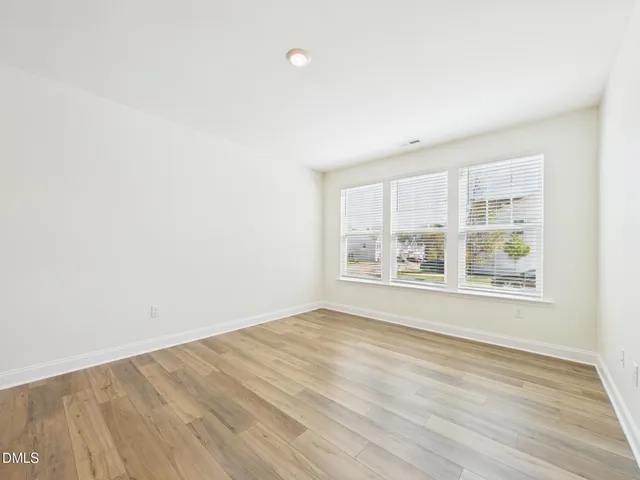 a view of kitchen with kitchen island white cabinets and refrigerator