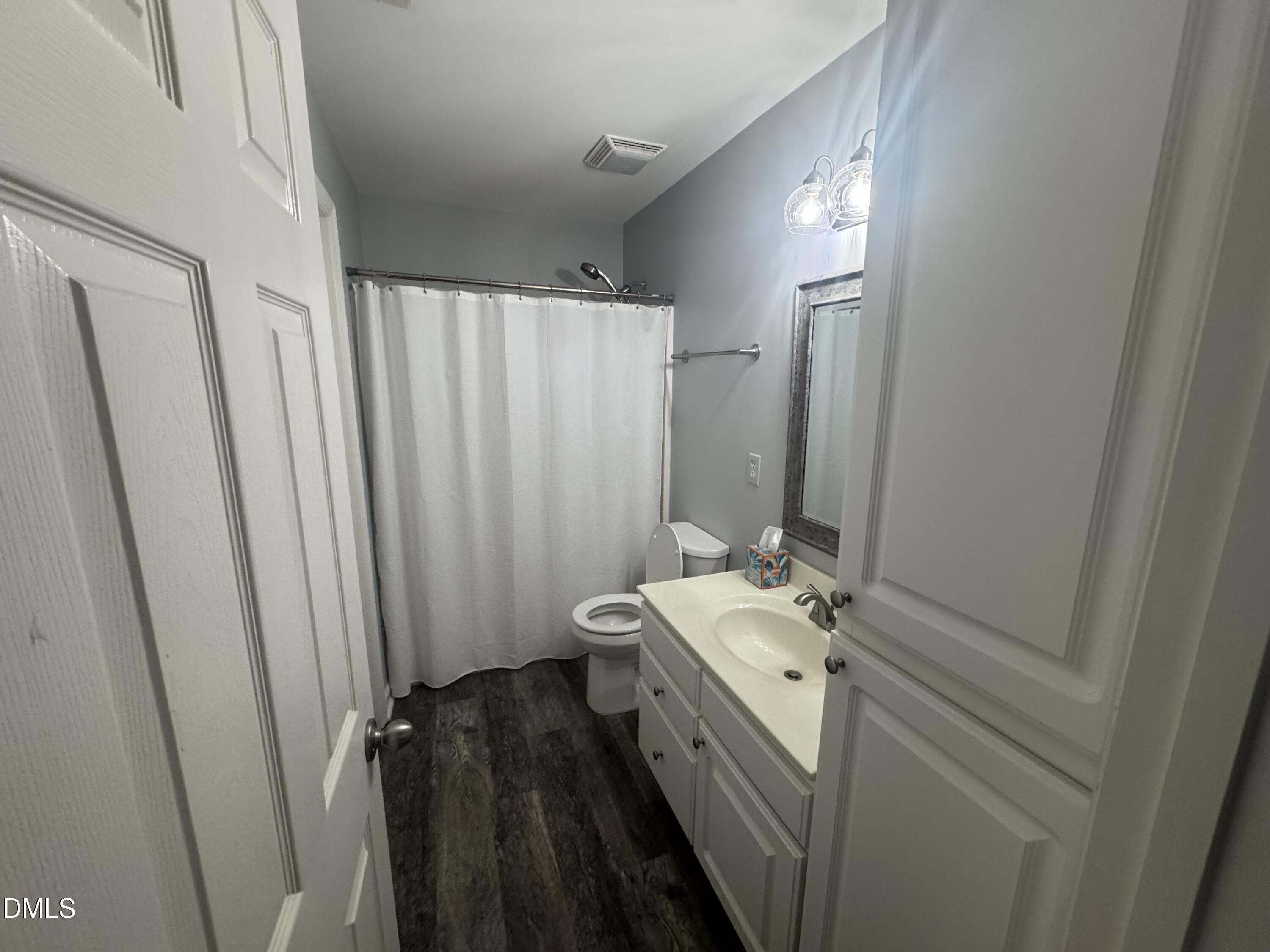 11351 Clubhaven Place, Unit 100 Raleigh, NC 27617 - Photo 26 of 29 a bathroom with a double vanity sink and a mirror