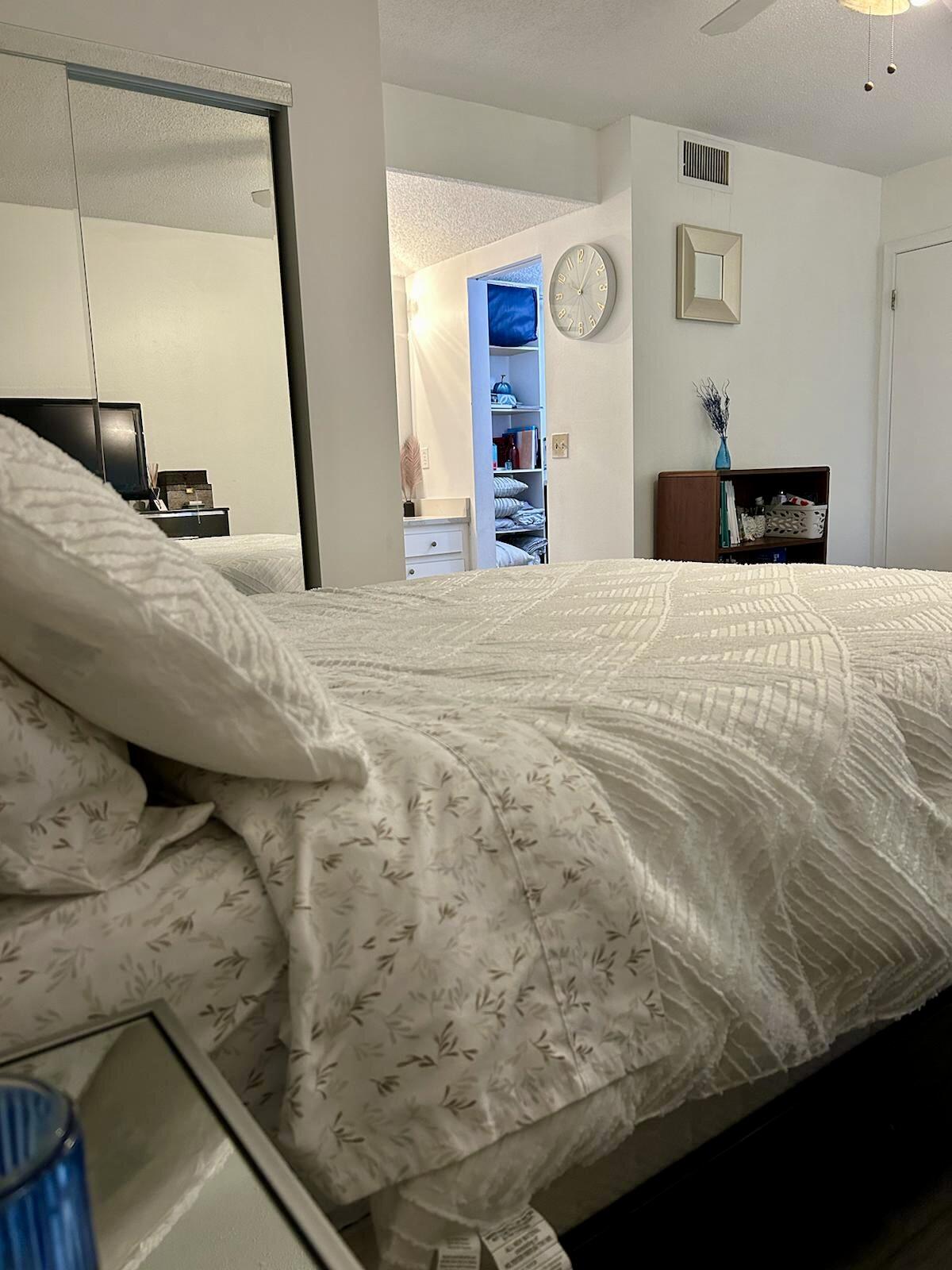 Undisclosed Address Delray Beach, FL 33445 - Photo 12 of 23 a bedroom with a bed and a mirror