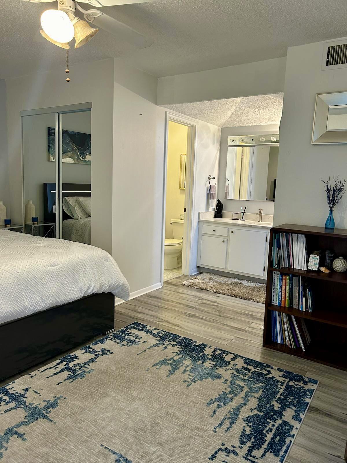 Undisclosed Address Delray Beach, FL 33445 - Photo 14 of 23 a bedroom with a bed and wooden floor