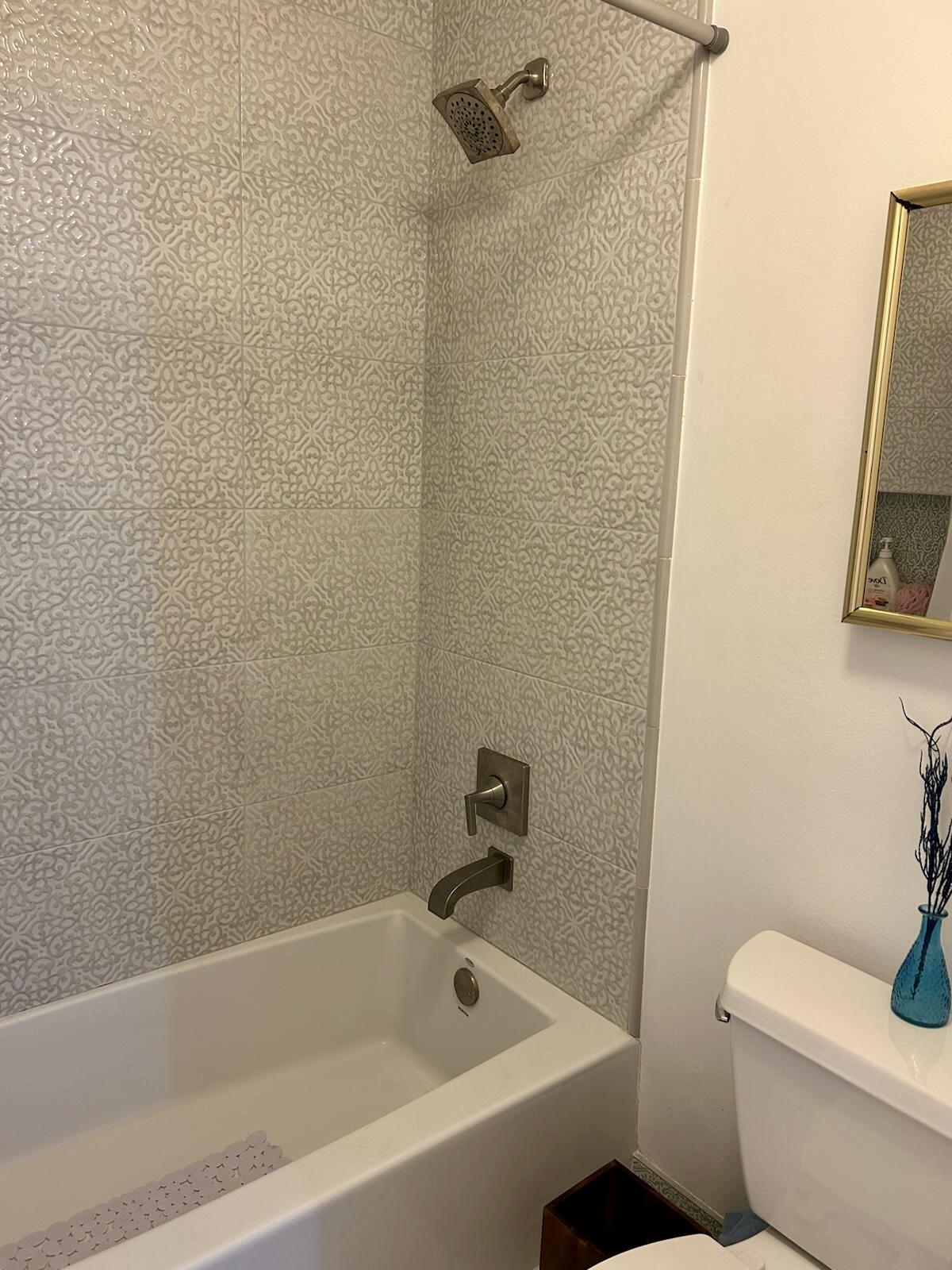 Undisclosed Address Delray Beach, FL 33445 - Photo 17 of 23 a white bath tub sitting next to a white toilet and sink