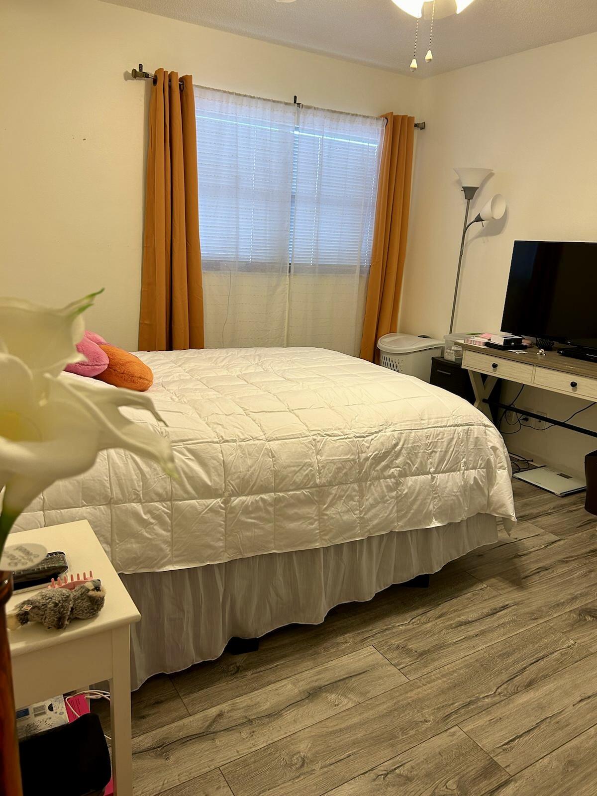 Undisclosed Address Delray Beach, FL 33445 - Photo 18 of 23 a bedroom with a bed and a flat screen tv