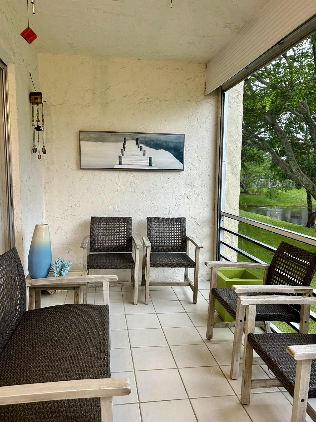 Undisclosed Address Delray Beach, FL 33445 - Photo 21 of 23 a living room with furniture and a floor to ceiling window