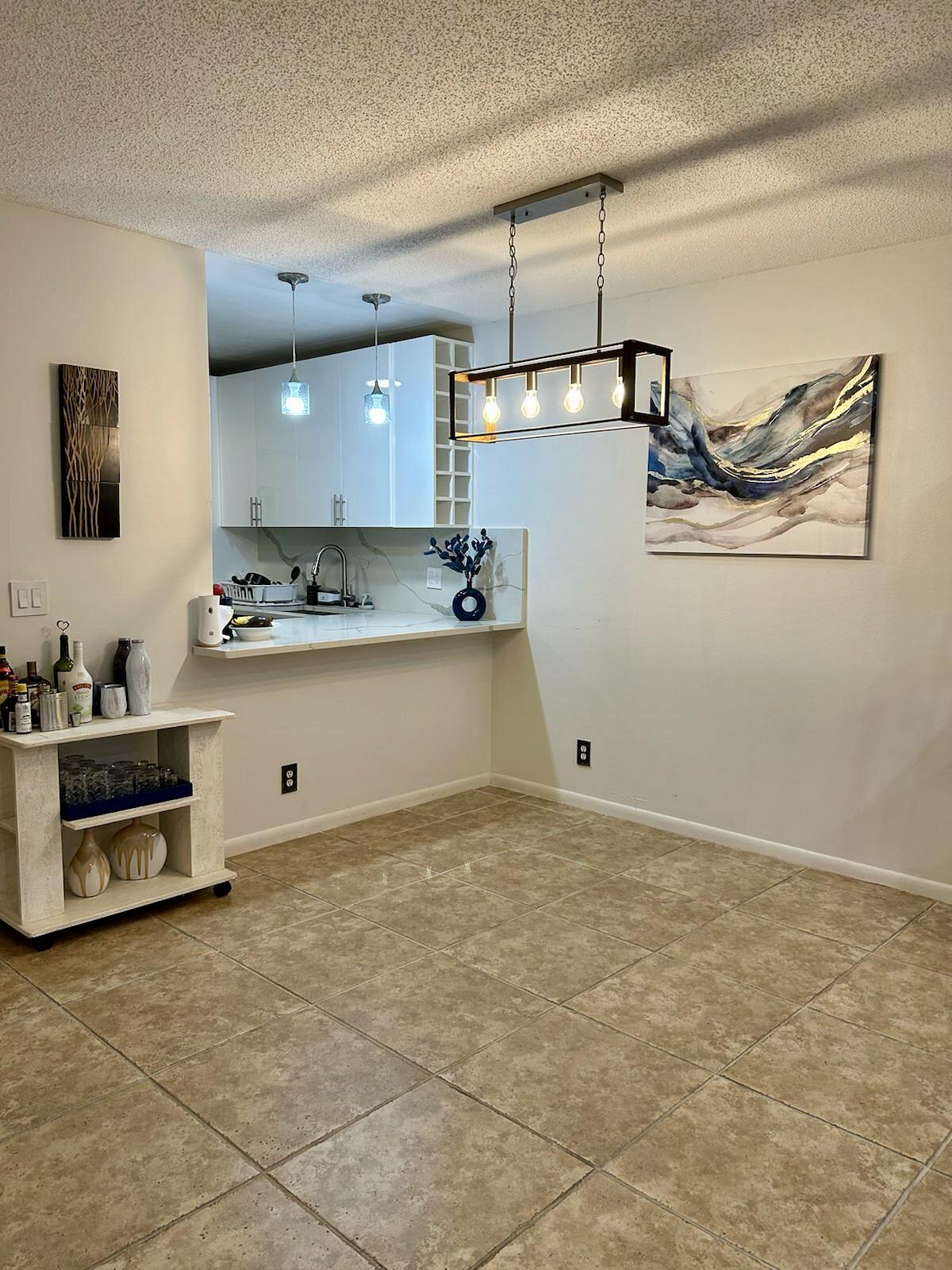 Undisclosed Address Delray Beach, FL 33445 - Photo 7 of 23 a view of a kitchen with a sink and cabinets