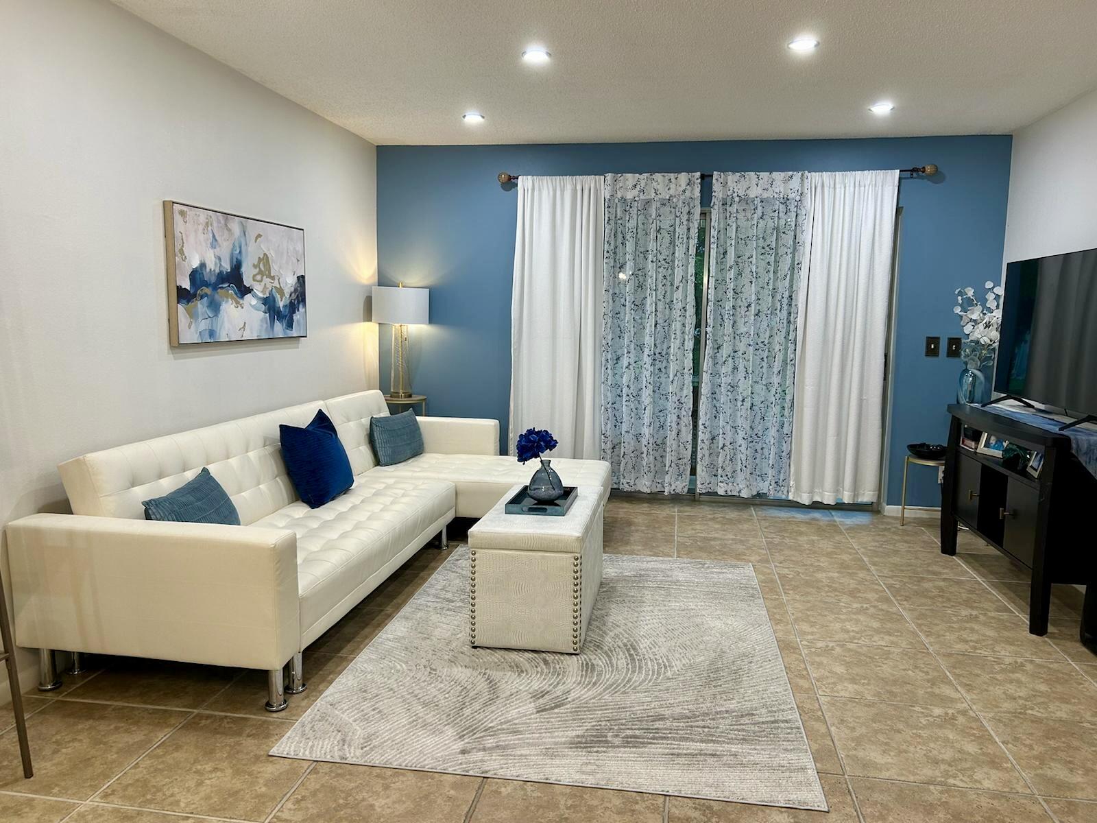 Undisclosed Address Delray Beach, FL 33445 - Photo 8 of 23 a living room with furniture and a flat screen tv