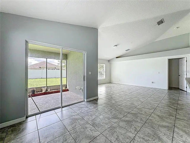 a kitchen with granite countertop a stove a sink and a refrigerator