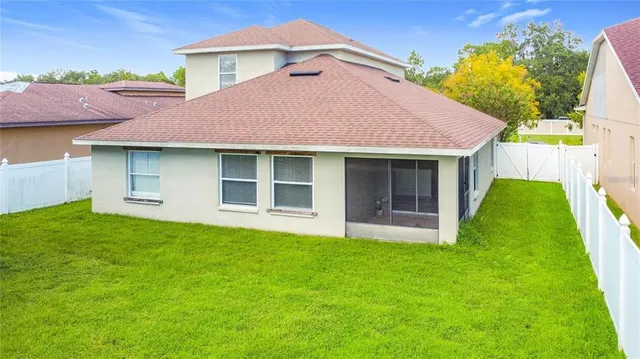 a view of a house with a yard and a garage