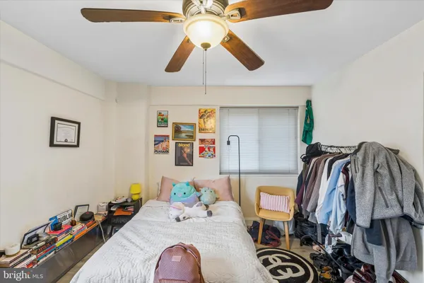 a bedroom with bed and a chandelier