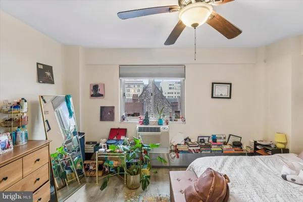 a living room with furniture chess floor and ceiling fan