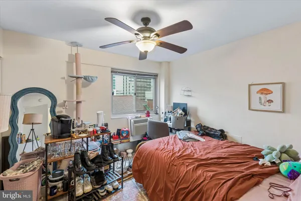 a bedroom with bed and a chandelier