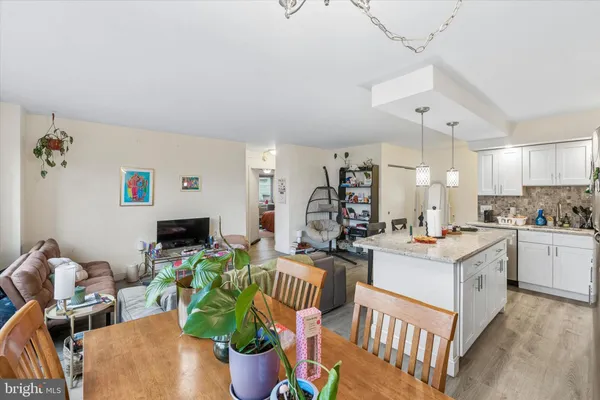 a living room with furniture a dining table and a fireplace