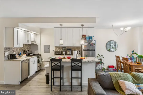 a view of kitchen with cabinets and furniture