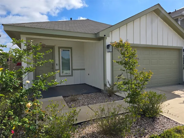 a house with a flower garden in front of it