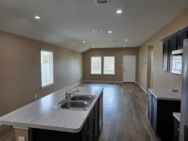 a kitchen with stainless steel appliances wooden cabinets and sink
