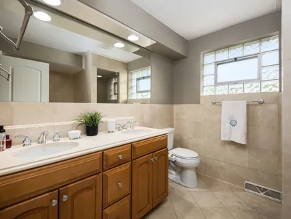 a bathroom with a tub a mirror and shower