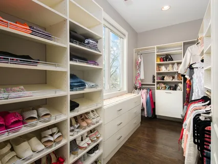 a large white kitchen with a large window