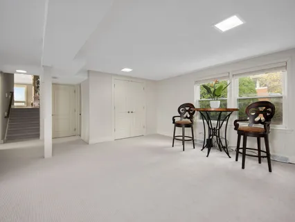 a living room with furniture large window and a flat tv screen
