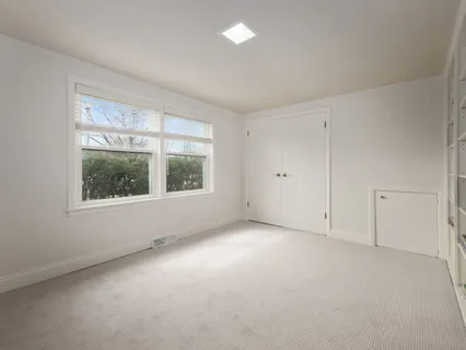 a bathroom with a toilet sink vanity granite and mirror