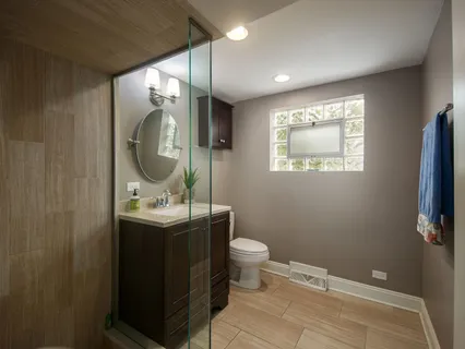 a living room with furniture a ceiling fan and a large window