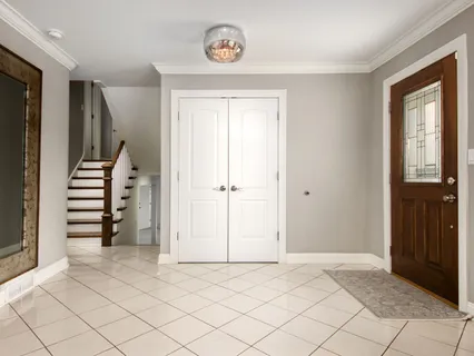 a living room with furniture a table and a floor to ceiling window