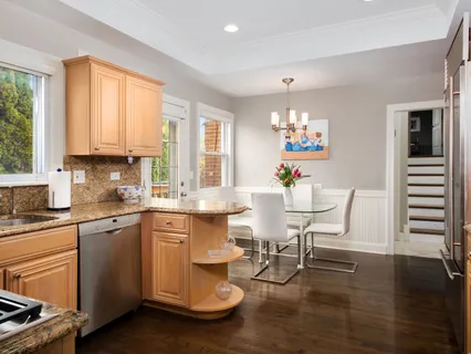a kitchen with granite countertop white cabinets stainless steel appliances and sink