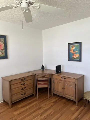 a view of a workspace with furniture and wooden floor