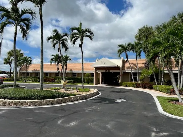 a front view of multiple houses with yard