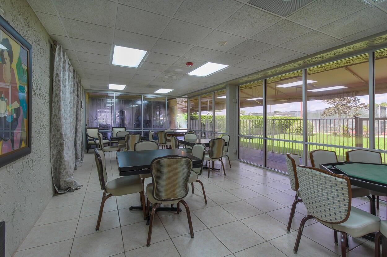 221 Lake Meryl Drive West Palm Beach, FL 33411 - Photo 26 of 31 a view of a dining room with furniture window and outside view
