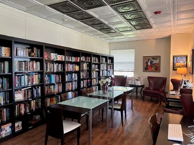 a view of a livingroom with furniture and a bookshelf