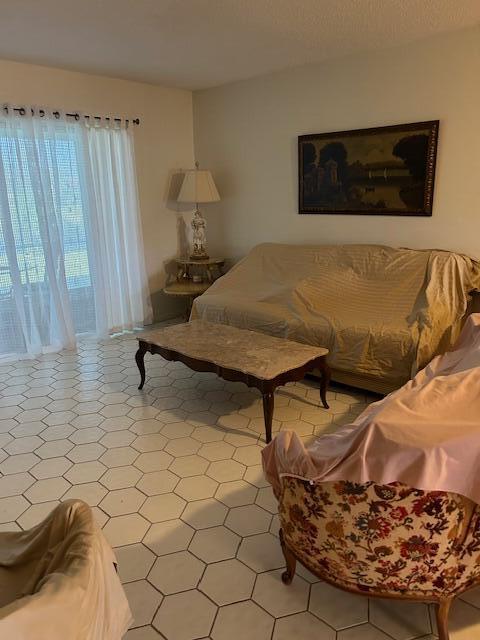 221 Lake Meryl Drive West Palm Beach, FL 33411 - Photo 7 of 31 a living room with a couch and a flat screen tv