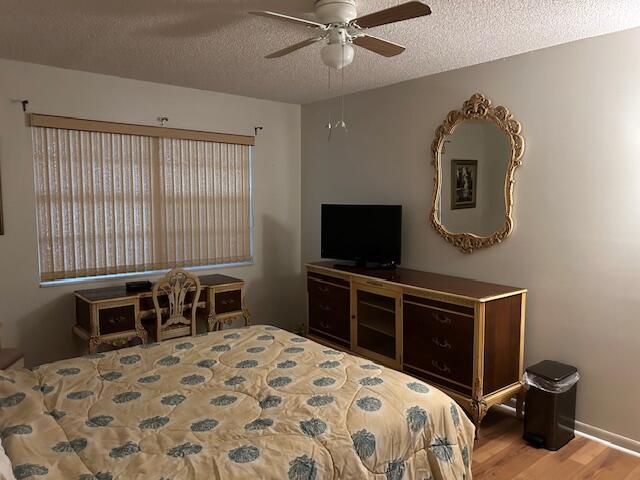221 Lake Meryl Drive West Palm Beach, FL 33411 - Photo 9 of 31 a bedroom with a bed and a flat screen tv