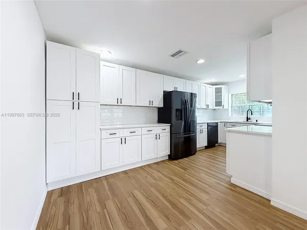a kitchen with stainless steel appliances granite countertop a sink and a stove