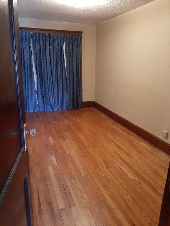 74 David Street Springfield, MA 01104 - Photo 4 of 12 a view of an empty room with wooden floor