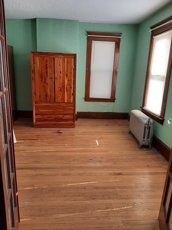 74 David Street Springfield, MA 01104 - Photo 7 of 12 a view of room with window and wooden floor