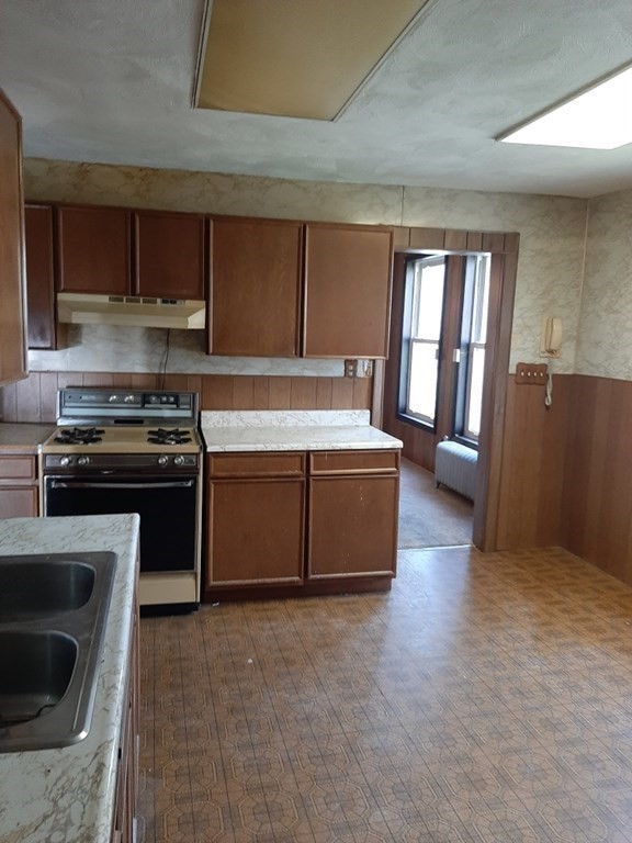 74 David Street Springfield, MA 01104 - Photo 8 of 12 a kitchen with a stove and a refrigerator